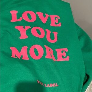 The label love you more Green Sweatshirt with Pink Text